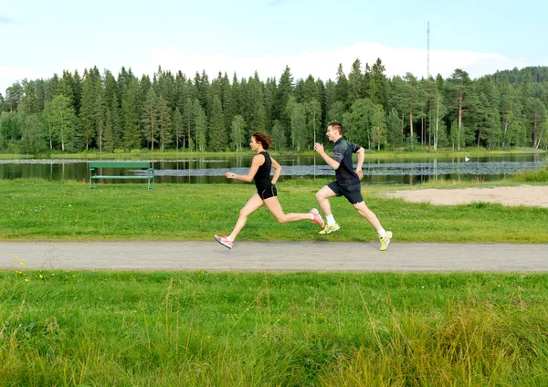 Young couple running outside — Stock Photo, Image