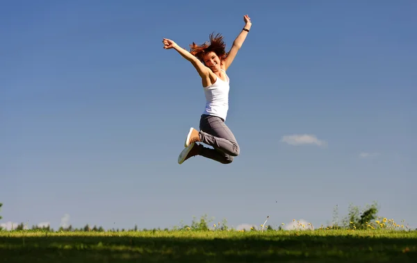 Young woman jumping outside — Stock Photo, Image