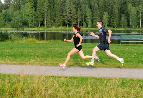 Young couple running outside — Stock Photo, Image