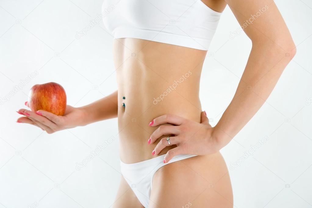 Young woman body and hand holding red apple isolated on white