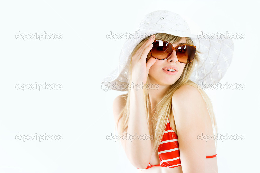 Portrait of pretty cheerful woman wearing red swimsuit and straw hat in sunny warm weather day