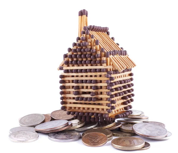 House made of matches is on the hill of coins Stock Image