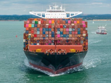 Bow of a Huge Container Ship at Sea Transporting Goods and Cargo clipart