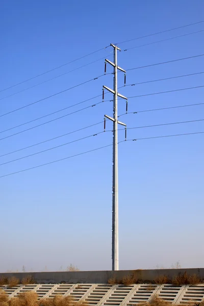 Mavi gökyüzü arka plan altında elektrik direkleri — Stok fotoğraf