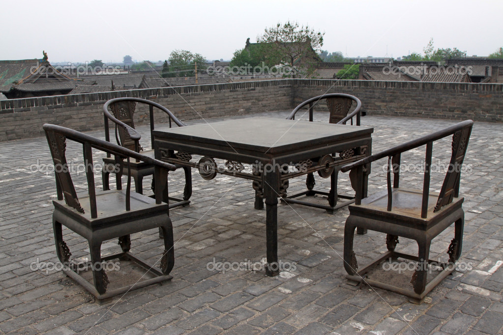 Desk and chair, the ancient city walls, having an antique flavou