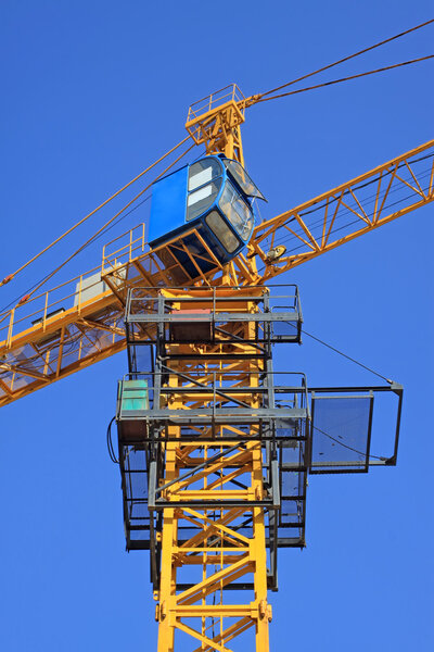 Tower crane under the blue sky background