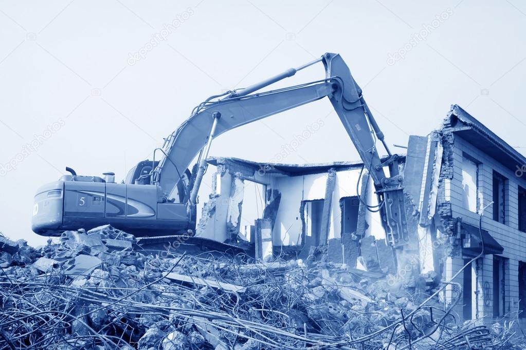 Excavator in the construction debris clean up site