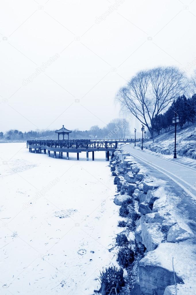 Chinese traditional style wooden bridge in the snow