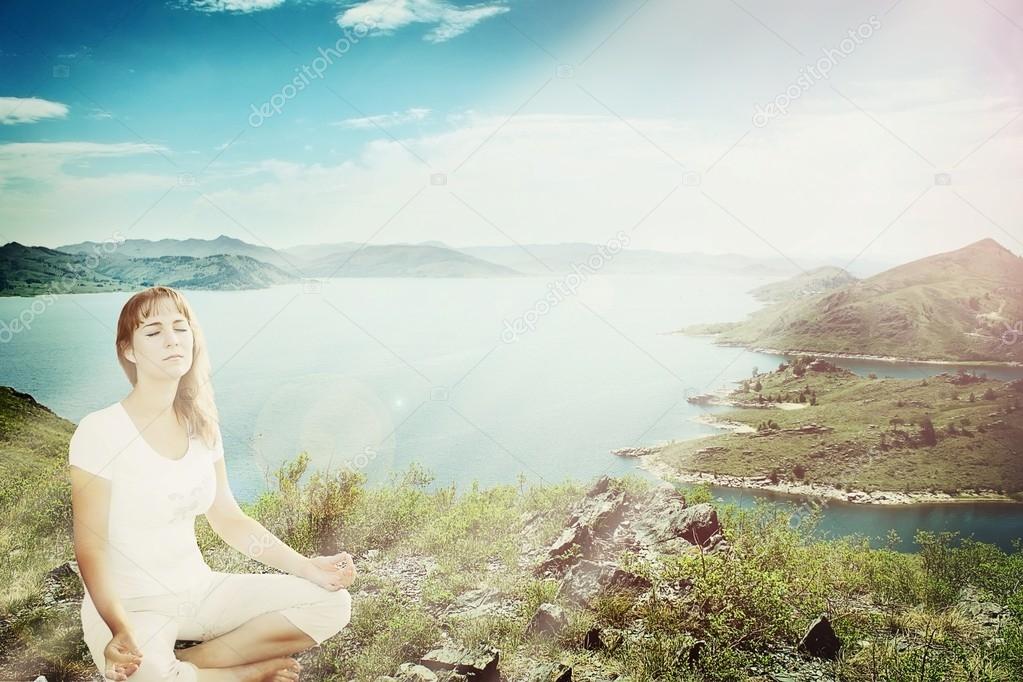 Beautiful girl meditating in lotus pose