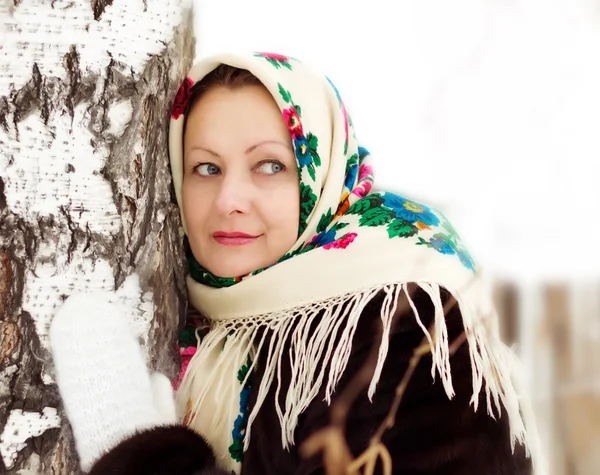 Woman in a painted shawl at a birch in winter — Stock Photo, Image