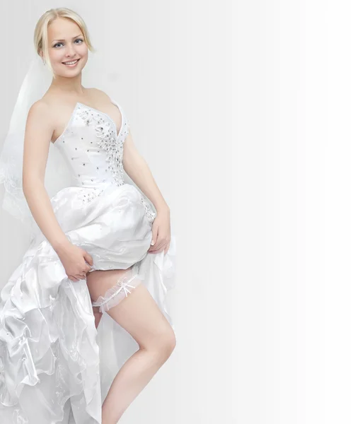 Beautiful young blonde woman showing a garter — Stock Photo, Image