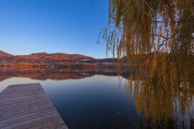 Sonbahar günbatımında göldeki tepelerin yansımaları.