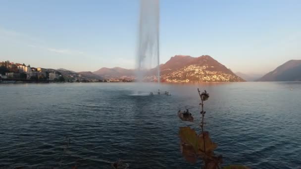 Water games made by a fountain on Lake Lugano at sunset — Stock Video