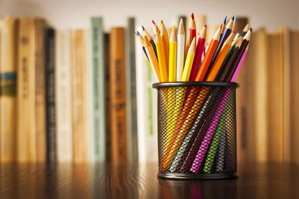 Wire desk tidy full of coloured pencils — Stock Photo, Image