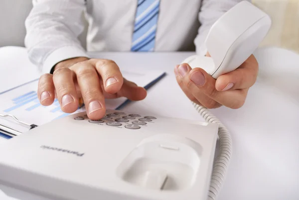 Man making a telephone call on a landline — Stock Photo, Image