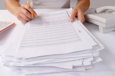 Hands holding a batch of loose paperwork clipart