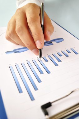 bir grafik üzerinde çalışan bir kalem tutan adam