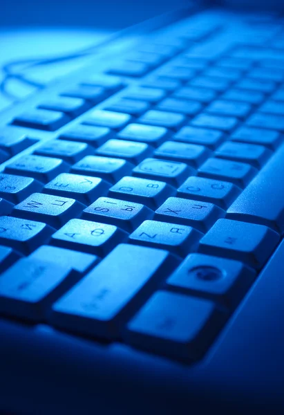 Computer keyboard in blue light — Stock Photo, Image