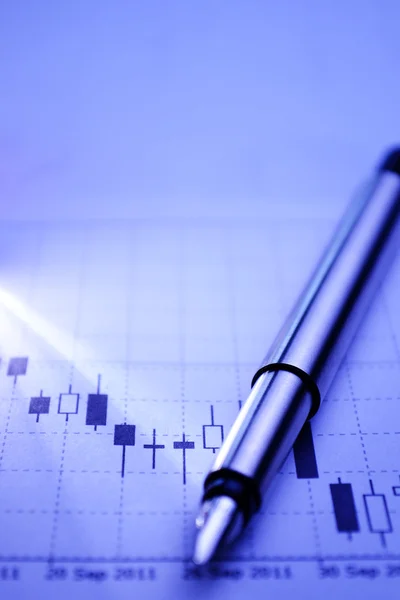 Silver pen on a business graph — Stock Photo, Image