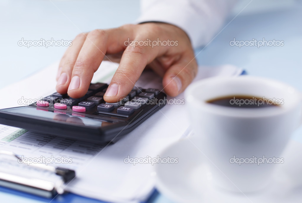 Man working with a calculator