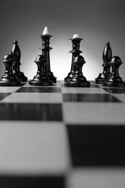 Backlit chess pieces on a chessboard — Stock Photo, Image