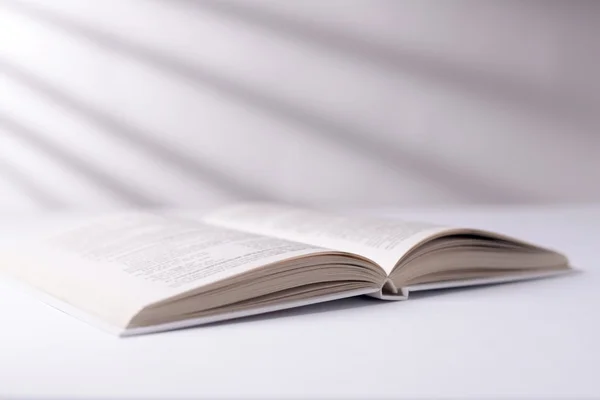 Open white book on a white surface — Stock Photo, Image