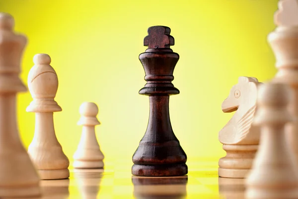 Chess pieces on a yellow background — Stock Photo, Image