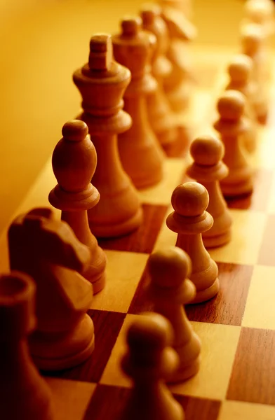 Chess pieces in yellow ambient light — Stock Photo, Image