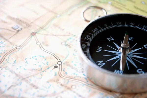 Handheld compass on a map Stock Picture