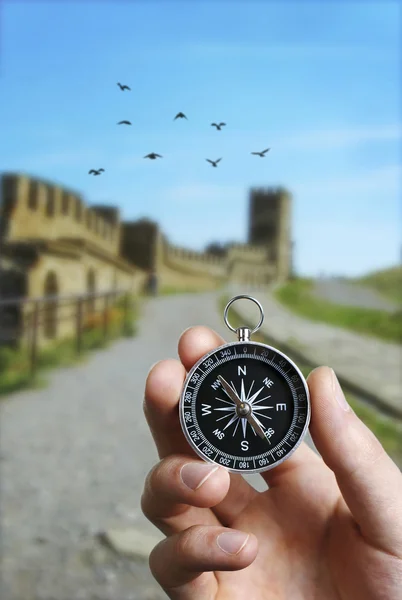 Man using a compass while sightseeing abroad