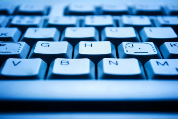 Computer keyboard in blue light — Stock Photo, Image