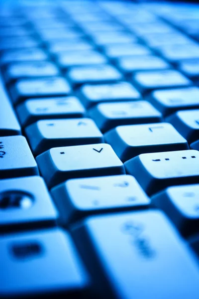 Computer keyboard in blue light — Stock Photo, Image