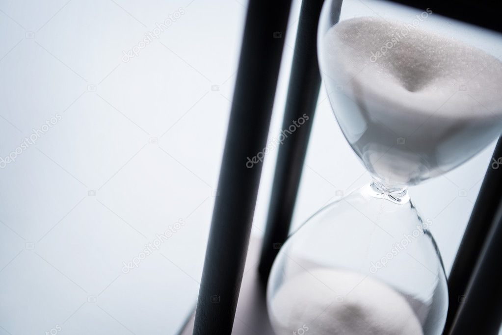 Sand running through an hour glass
