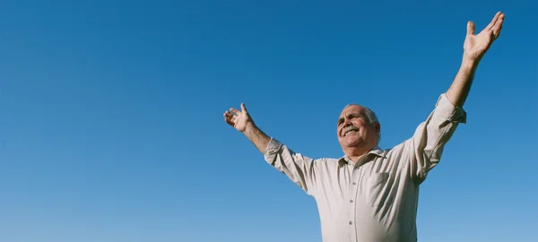 Happy joyful elderly man embracing the sun — Stock Photo, Image