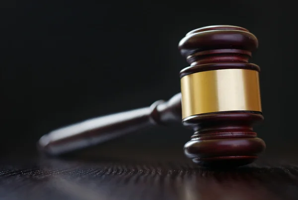 Wooden brass bound gavel on a desk top — Stock Photo, Image