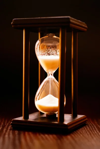 Illuminated hourglass in a wooden frame — Stock Photo, Image