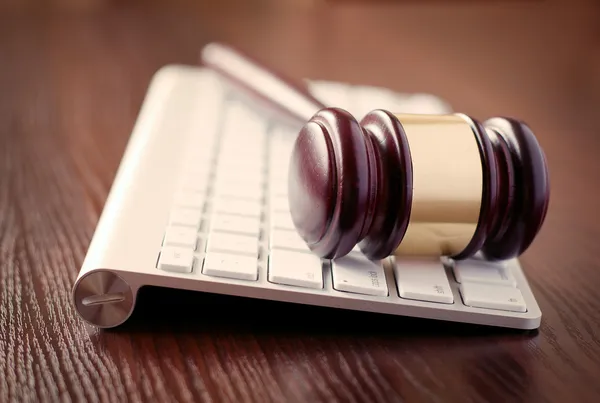 Wooden judges gavel on a computer keyboard — Stock Photo, Image