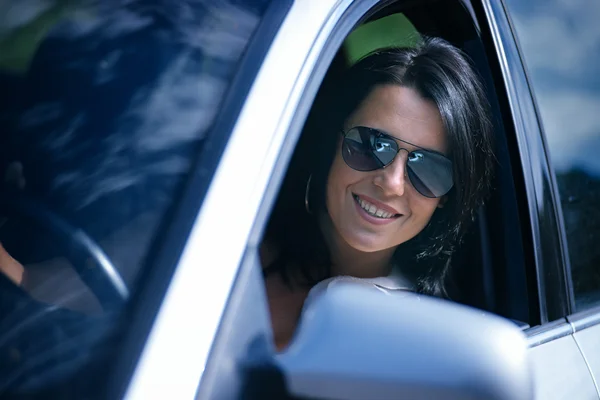 Beautiful young woman driving a car — Stock Photo, Image