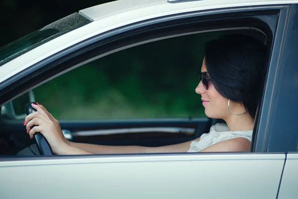 Beautiful young woman driving a car — Stock Photo, Image