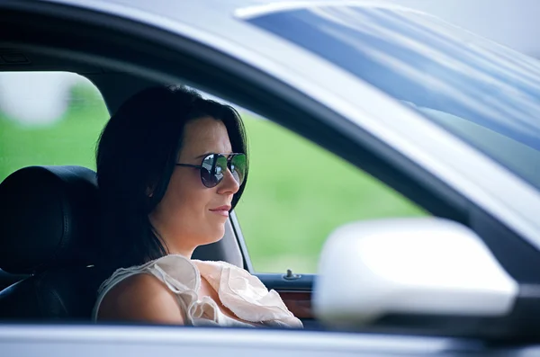 Beautiful young woman driving a car — Stock Photo, Image