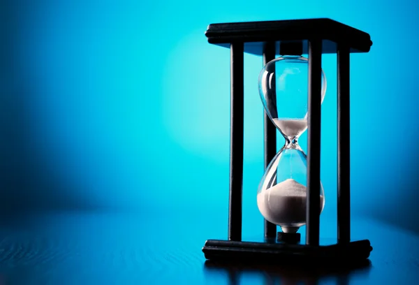 Egg timer or hourglass on a blue background — Stock Photo, Image