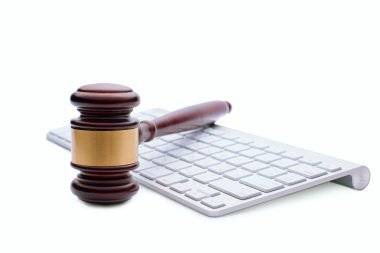 Wooden gavel on a white computer keyboard clipart