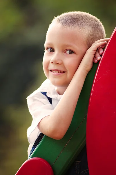 Cute little boy in a colorful kids playground — Stock Photo, Image