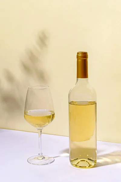 Unlabelled Bottled White Wine Half Empty Wineglass Standing White Table — Stock Photo, Image
