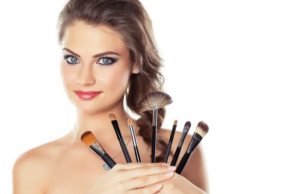 Woman with make-up brushes — Stock Photo, Image