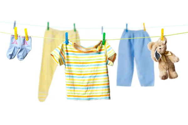 Drying baby clothes and a teddy bear — Stock Photo, Image