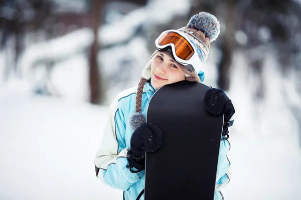Улыбающаяся девушка держит сноуборд — стоковое фото