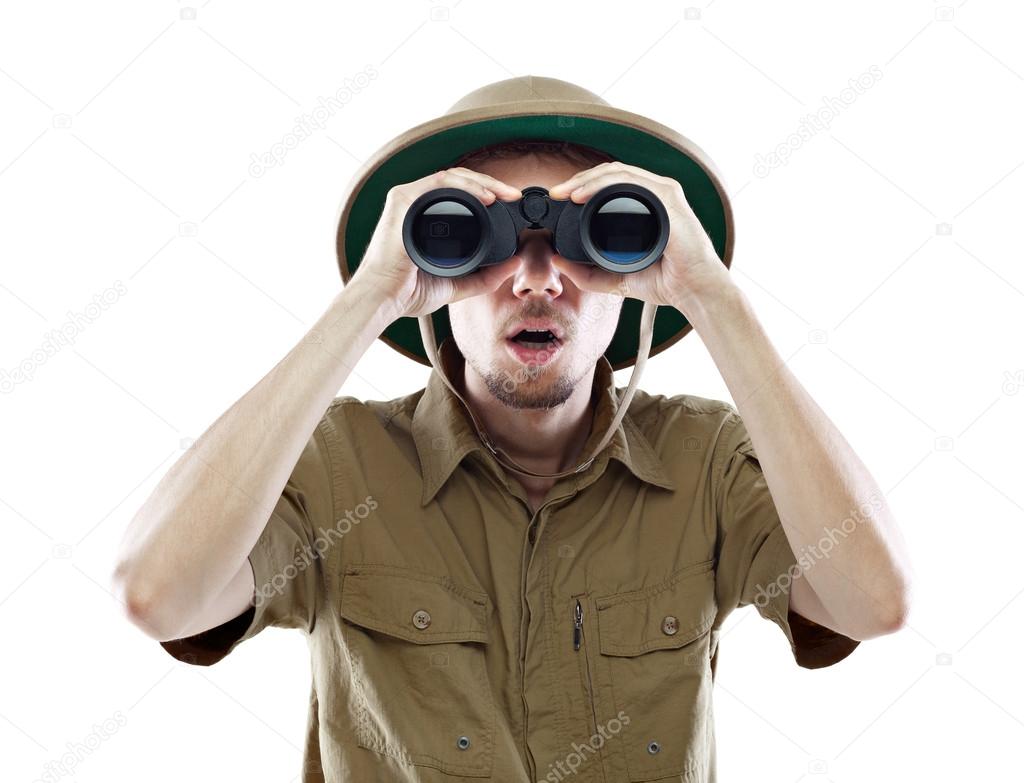 Surprised explorer looking through binoculars