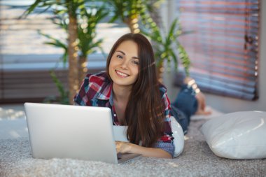 Woman surfing the net at home clipart