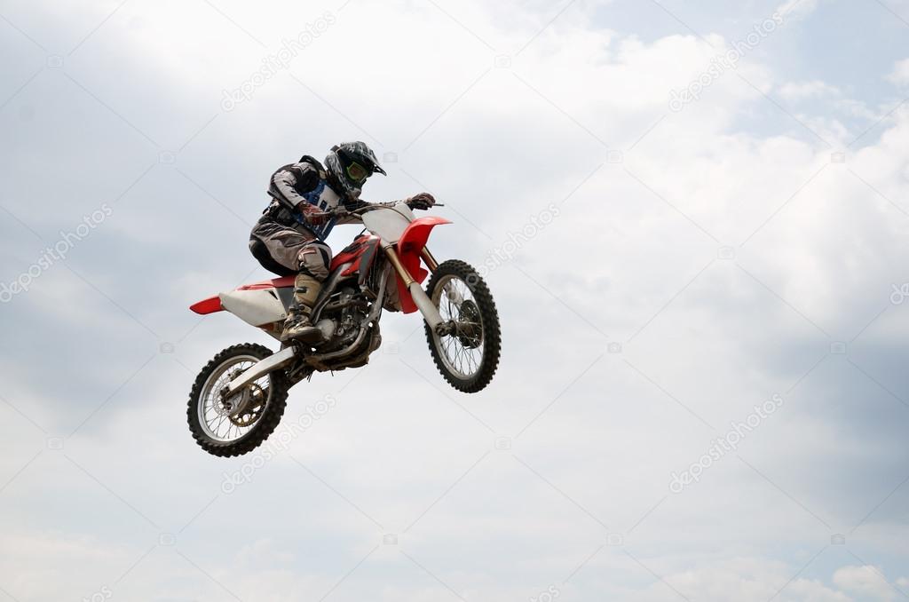 Rider soaring flight with a turn of the wheel motocross bike